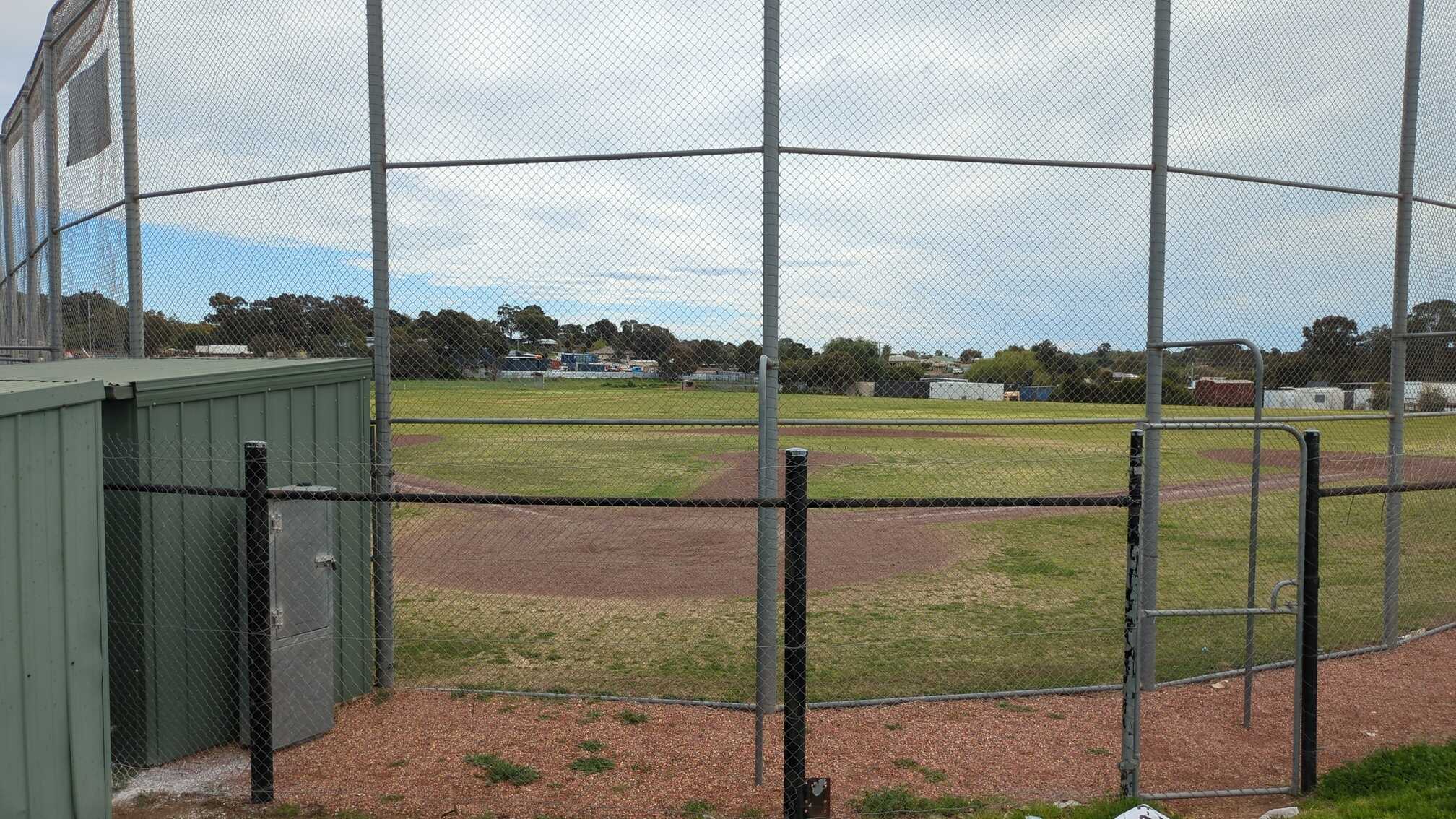 A sports field with a baseball diamond